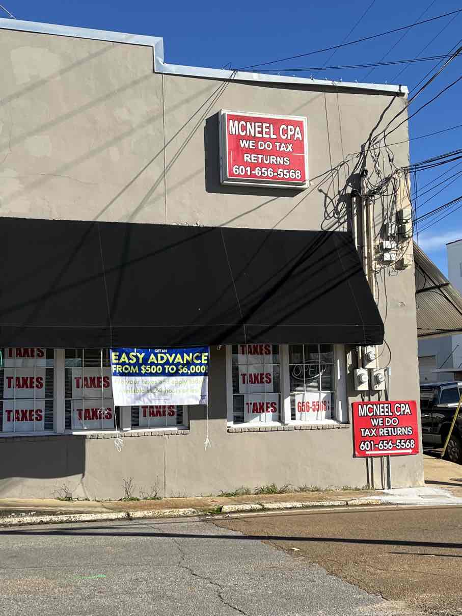 McNeel CPA office building at 307 W Main St, Philadelphia, MS showing WE DO TAX RETURNS sign